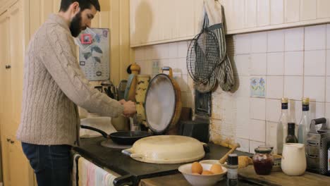 Man-preparing-breakfast-in-kitchen