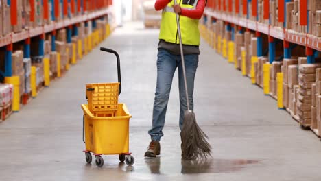 Female-warehouse-worker-moping-floor