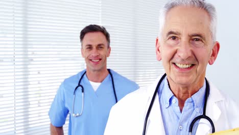 Portrait-of-male-doctors-and-coworker-standing-with-arms-crossed