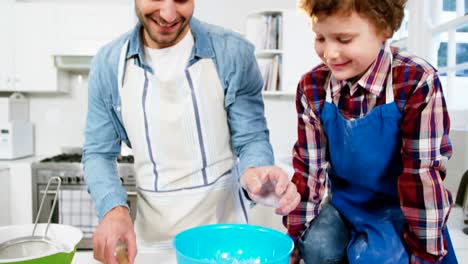 Father-teaching-his-son-how-to-make-cupcake