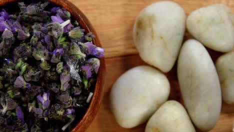 Wooden-bowl-with-lavender-petals-and-pebble-stone