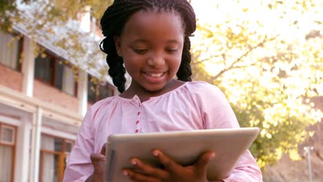 Cute-schoolgirl-using-digital-tablet