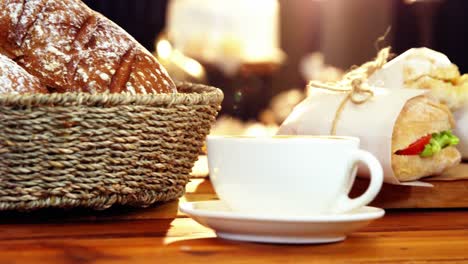Basket-of-bread-and-coffee-cup-in-counter