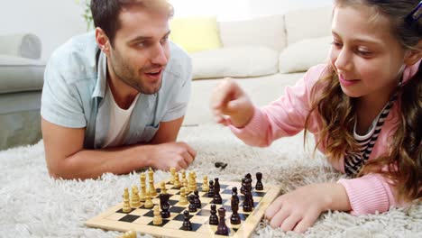 Father-and-daughter-playing-chess-in-the-living-room