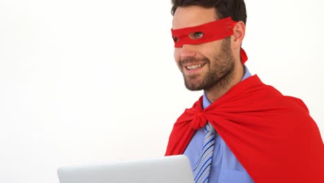 Businessman-using-laptop-pretending-to-be-a-super-hero