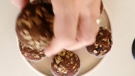 Close-up-of-hand-holding-muffins