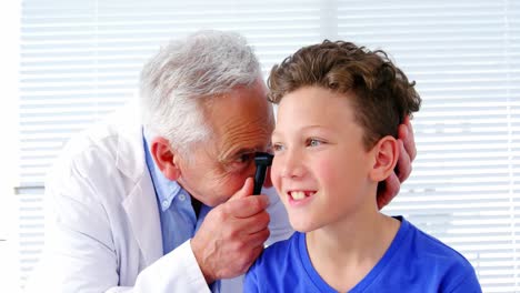 Médico-Varón-Examinando-El-Oído-De-Un-Paciente-Con-El-Horóscopo