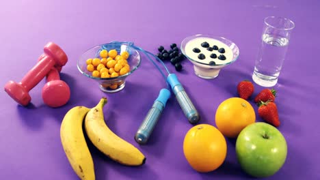 Dumbbells,-banana,-water-glass,-fruit,-skipping-rope-and-breakfast
