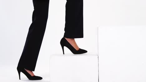 Low-section-of-businesswoman-walking-on-steps