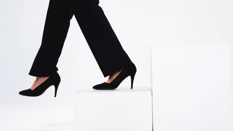 Low-section-of-businesswoman-walking-on-steps