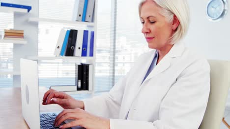 Female-doctor-working-over-laptop