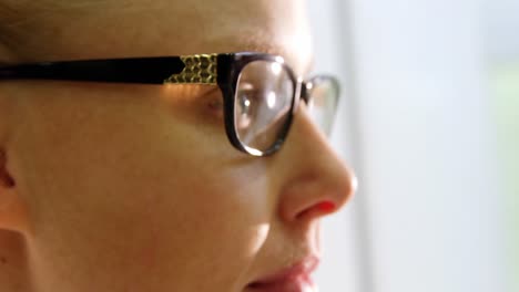 Close-up-of-female-customer-trying-spectacles