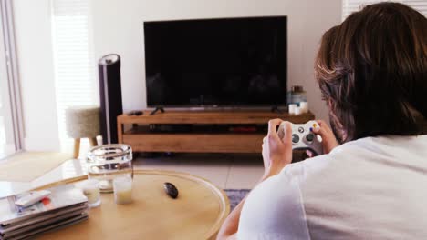 Man-playing-video-games-in-living-room