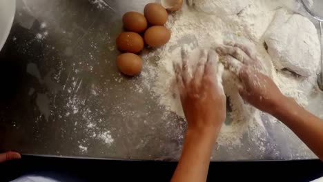 Hands-of-chef-preparing-cake