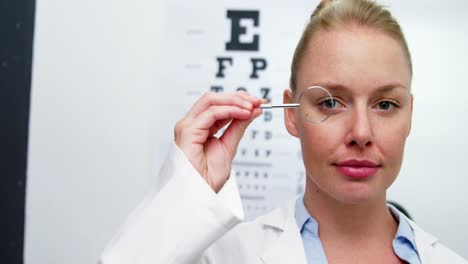 Female-optometrist-looking-through-magnifying-glass