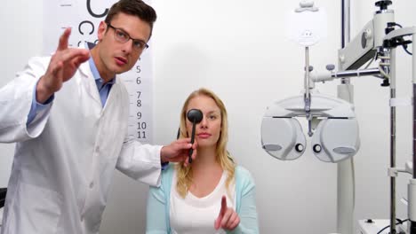 Optometrist-examining-female-patient-with-medical-equipment
