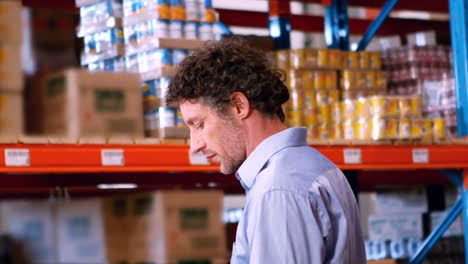 Businessman-standing-and-checking-inventory-stock