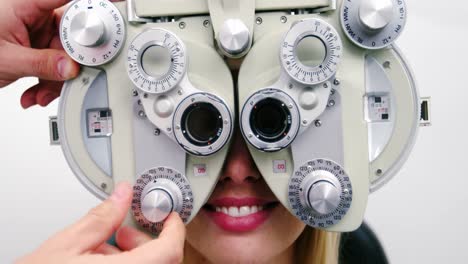 Optometrist-examining-female-patient-on-phoropter