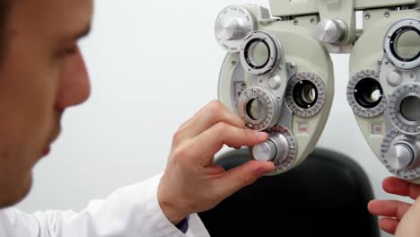 Optometrist-adjusting-phoropter