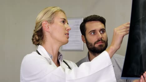Physiotherapist-explaining-x-ray-to-patient