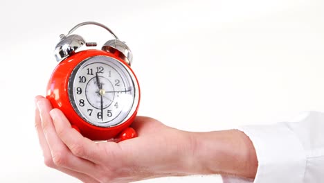 Man-hand-holding-alarm-clock