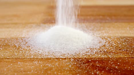 Sugar-pouring-on-a-wooden-table