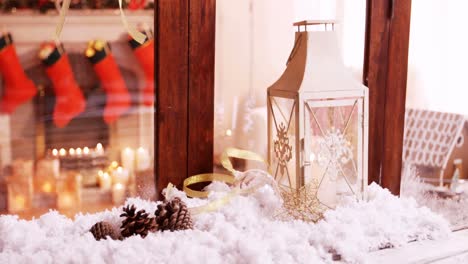 Pine-cone-and-lantern-decoration-on-fake-snow