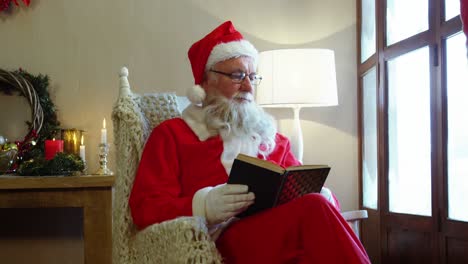 Santa-claus-looking-through-window-while-reading-a-novel