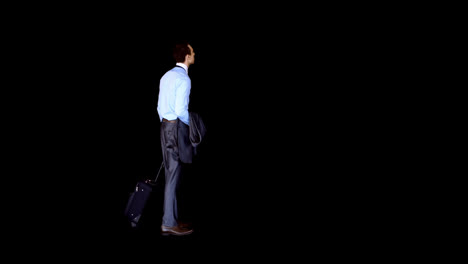 Businessman-standing-with-his-luggage