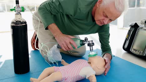 Male-paramedic-giving-oxygen-to-a-dummy