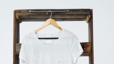 T-shirt-hanging-on-a-wooden-frame