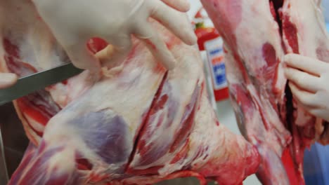 Butcher-cutting-meat-at-meat-factory