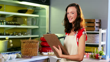 Female-staff-making-a-checklist-at-counter