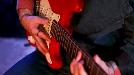 Mid-section-of-musician-playing-guitar
