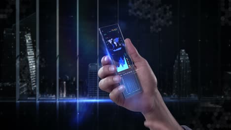 Hand-holding-futuristic-mobile-phone-against-digitally-generated-background