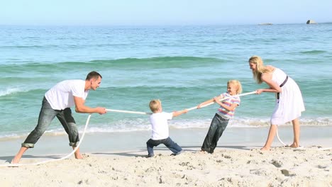 Family-playing-with-a-string-on-the-beach