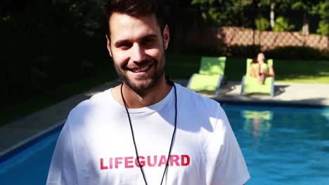 Lifeguard-looking-at-stopwatch-near-the-poolside