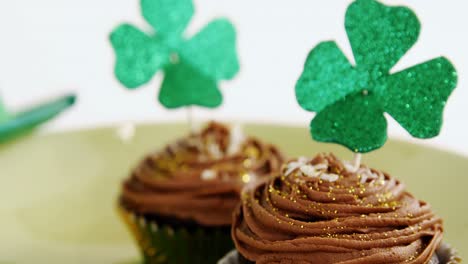 Chocolate-muffin-with-chocolate-cream-topping-and-shamrock-stick-for-st-patricks