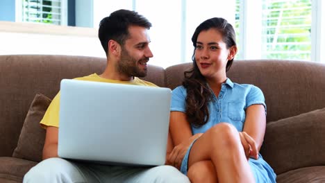Couple-using-laptop-in-the-living-room