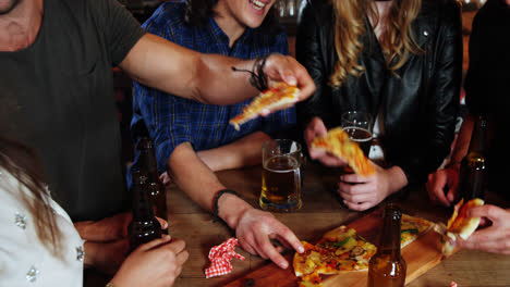 Group-of-friends-interacting-while-having-pizza