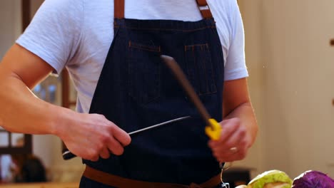 Chef-sharpening-his-knife