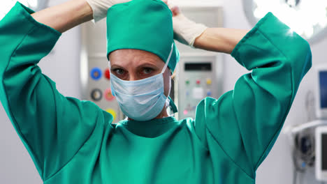 Female-nurse-tying-surgical-mask-in-operation-theater