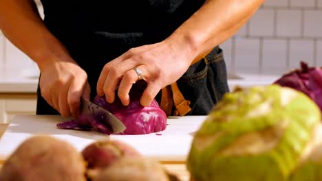 Chef-cutting-purple-cabbage-in-cafe-kitchen