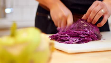 Chef-chopping-purple-cabbage-in-cafe-kitchen