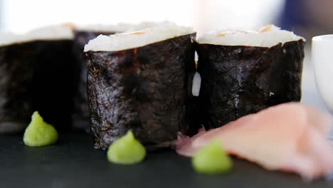 Maki-Sushi-Servido-Sobre-Pizarra-De-Piedra-Gris-Con-Salsa-De-Soja