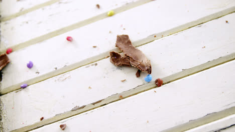 Broken-chocolate-Easter-egg-on-wooden-plank