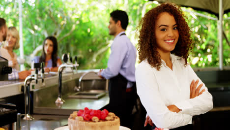 Female-waitress-standing-with-arms-crossed