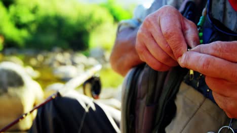 Fly-fisherman-preparing-bait-for-fishing