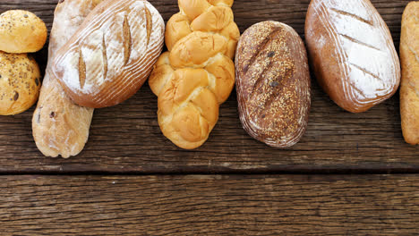 Various-bread-loaves-arranged-on-wooden-background