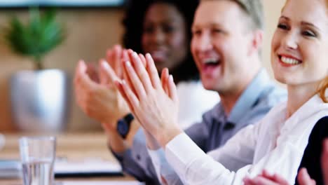 Executives-applauding-in-conference-room